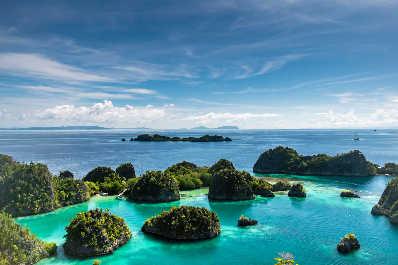 Photo by sutirta budiman islets surrounded by body of water during daytime